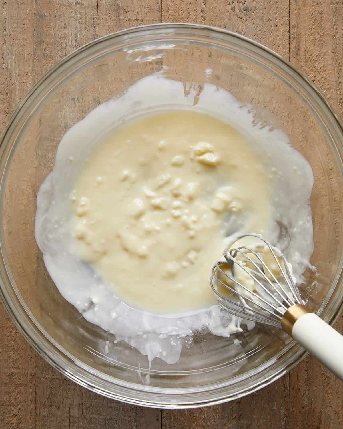 Overhead image of melted butter being whisked in a bowl, a key step for making no chill chocolate chip cookies with a rich, chewy texture.