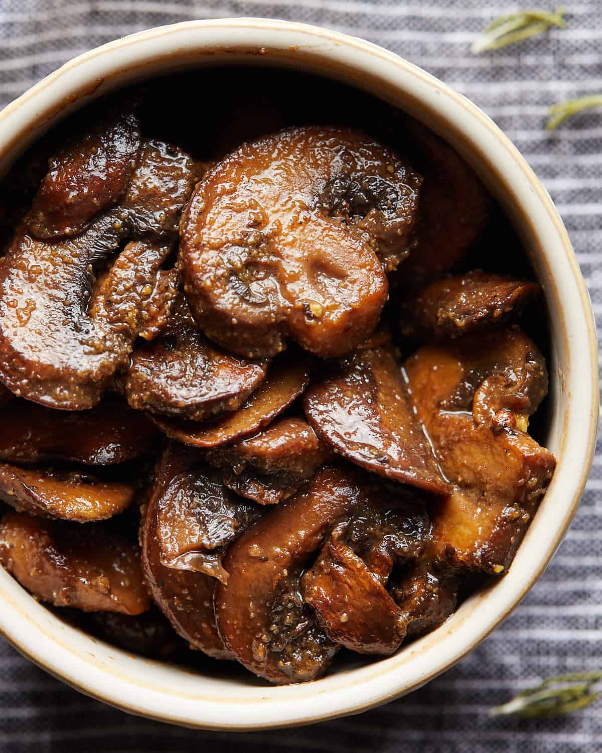 Close-up of browned sliced mushrooms served in a small bowl.