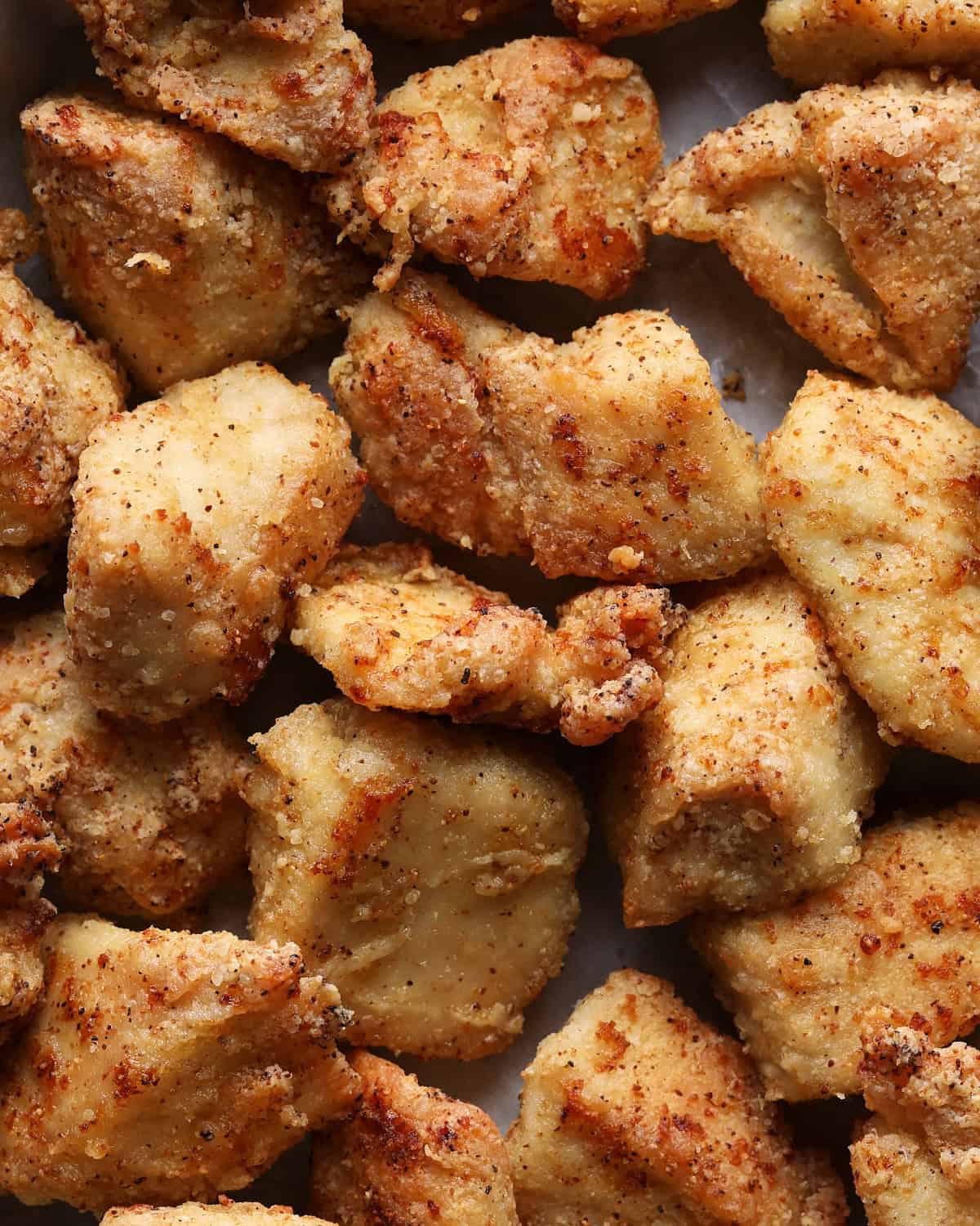 Close-up of crispy air fryer chicken bites seasoned with seasoned salt.