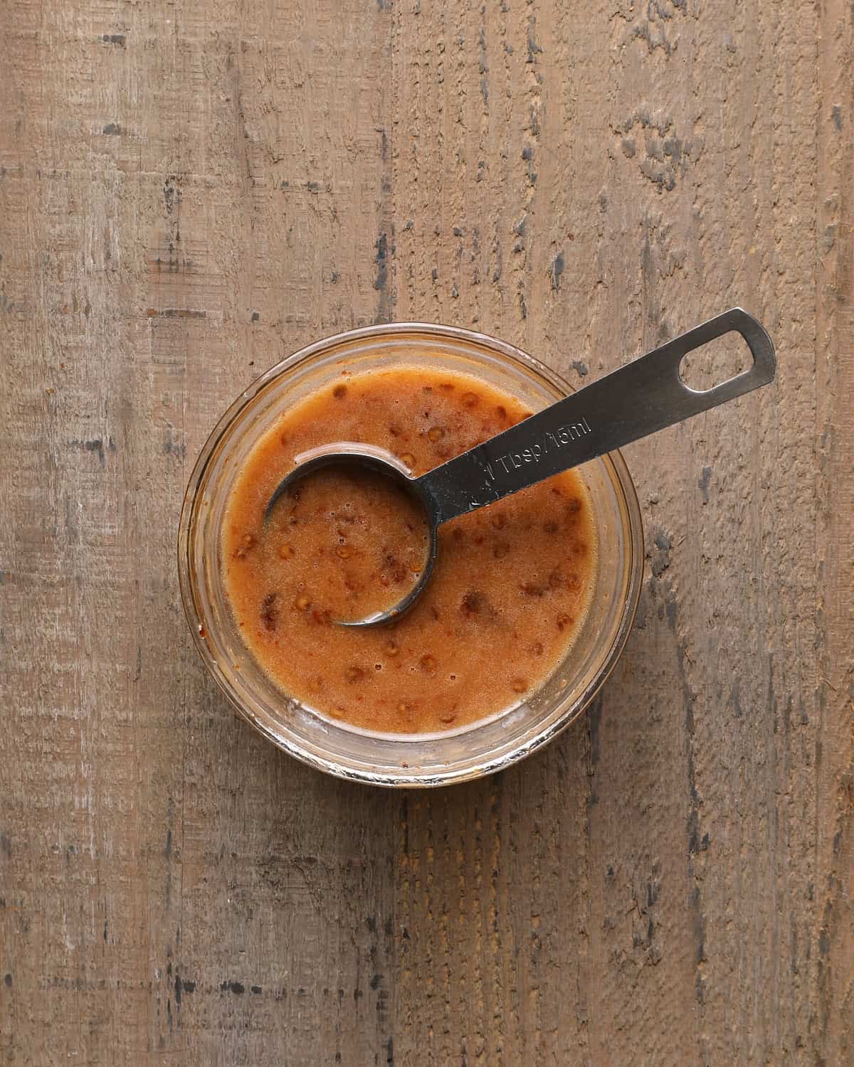Hot honey in a small bowl with a spoon.