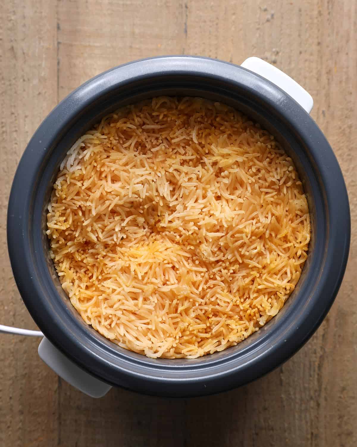 Tomato rice cooked in a rice cooker for street corn chicken bowls.
