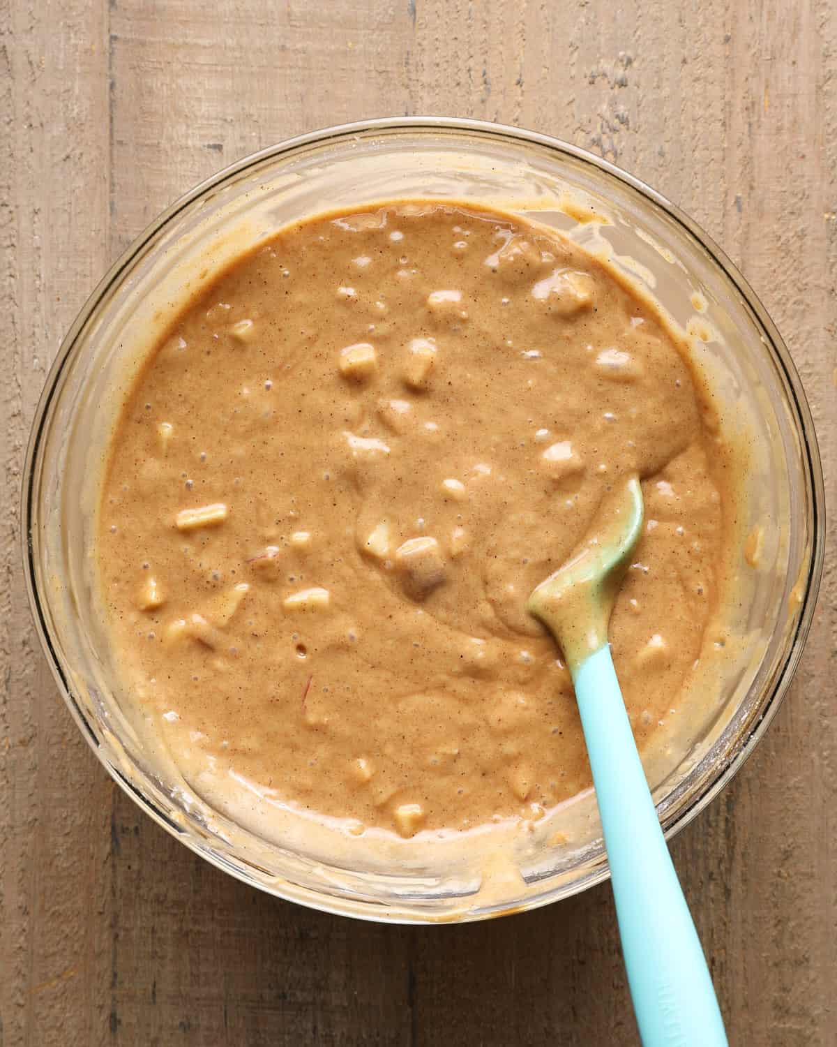 Thick apple cider muffin batter with finely diced apples folded in.